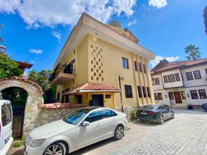 a white car parked in front of a building at Ali Apart in Antalya