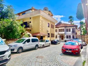 a group of cars parked in front of a building at Ali Apart in Antalya