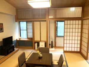 a room with a table and chairs and windows at Setsugetsuka - Vacation STAY 34181v in Nikko