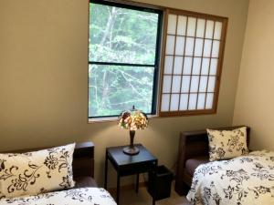 a bedroom with a bed and a window and a table at Setsugetsuka - Vacation STAY 34181v in Nikko