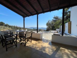 patio con mesa, sillas y vistas en Onar Houses, en Achladies
