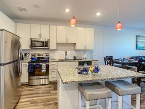 a kitchen with a counter top with a refrigerator at Perfect And Close To Disney! in Kissimmee