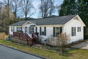 a small white house with a porch and a driveway at Spacious & Peaceful Retreat 3 miles to Biltmore in Asheville