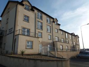 a large tan building with a balcony at Atlantic View in Bundoran