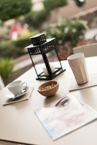 a table with coffee cups and a bird feeder on it at Sotavento Beach Club in Costa Calma