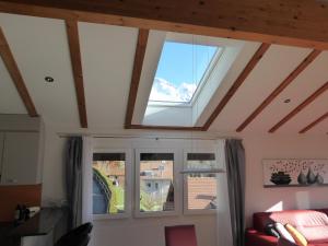 a living room with a skylight and two windows at Chalet Gerbera in Wengen