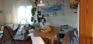a living room with a wooden table and a couch at 4 Vents Cala Galdana in Cala Galdana