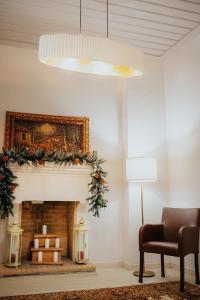 a living room with a fireplace with christmas decorations at 1909 Guesthouse in Kalavrita