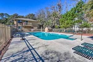 a swimming pool with chairs and a fence at 5 MIN WALK TO BEACH- 2BR1BA Villa in The Dunes in Hilton Head Island