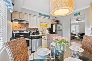 a kitchen with a glass table with chairs at 5 MIN WALK TO BEACH- 2BR1BA Villa in The Dunes in Hilton Head Island