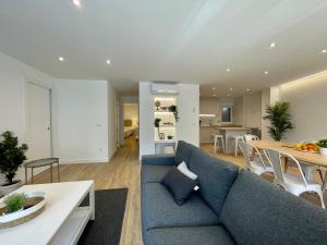 a living room with a blue couch and a table at VUT Correhuela in Salamanca