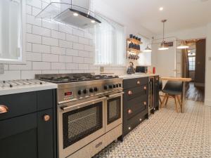 a kitchen with a stove and a counter top at Cornerside in Sidmouth