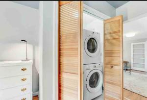 a laundry room with a washer and dryer at River Front In The Heart Of Ithaca in Ithaca