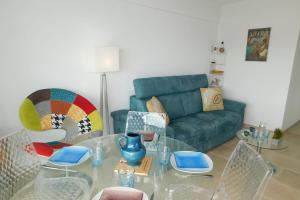 a living room with a glass table and a couch at Charming T2 "Sainte Marguerite" with air conditioning sea view and parking in Antibes