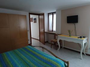 コステルマーノにあるAppartamento gialloのベッドルーム(ベッド1台、デスク、テレビ付)