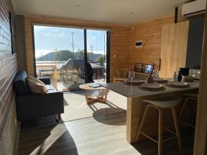 a room with a kitchen with a table and a balcony at Cabañas La Matanza in Matanzas