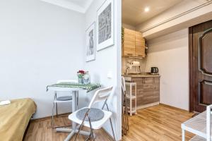 a small kitchen with a table and chairs in a room at Prusu 17a in Rīga