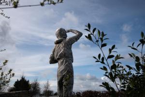 a statue of a person looking up at the sky at The Landing Hotel in Westerham
