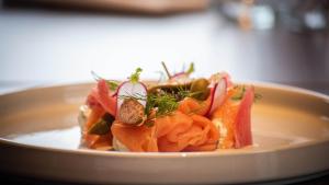 a plate of food with carrots and other vegetables at The Landing Hotel in Westerham