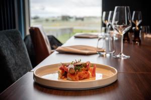 a plate of food on a table with wine glasses at The Landing Hotel in Westerham
