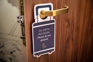 a door with a sign on it with a door knob at The Landing Hotel in Westerham