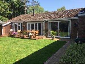 a house with a patio with a table and chairs at 9 Chudleigh Close in Bedford