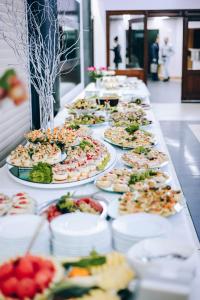 a buffet line of plates of food on a table at Hotel Podróżnik in Koszuty