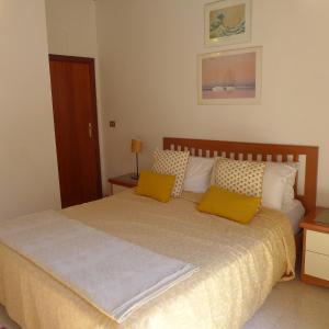 a bedroom with a bed with two yellow pillows at Casa in Piazza in Vasto