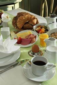 una mesa con un plato de comida y una taza de café en Parkhotel Plauen en Plauen