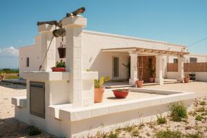 a house in the desert with a bird sitting on top of it at Villa Susca - villa sul mare in Monopoli