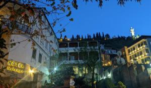 a view of a city at night with a building at Hotel Kalanga in Tbilisi City