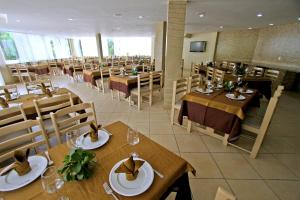 un comedor con mesas y sillas en un restaurante en Petrolina Palace Hotel en Petrolina