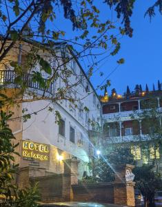 a hotel with a sign on the side of a building at Hotel Kalanga in Tbilisi City