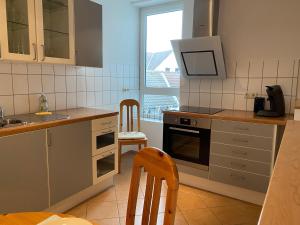 a kitchen with a sink and a stove top oven at Apartment am Elm in Königslutter am Elm