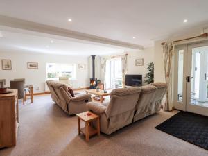 a living room with two couches and a table at Oak Bank in Windermere