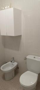 biała łazienka z toaletą i umywalką w obiekcie Maravilloso piso de dos dormitorios en Huéscar w mieście Huéscar