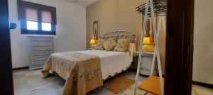 een slaapkamer met een bed, een ladekast en een raam bij Apartamento Moctezuma in Ronda