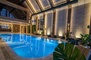 a large swimming pool in a building at Apartman Gnezdo - Titova vila Zlatibor in Zlatibor