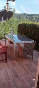 a ping pong table and two chairs on a patio at Ferienhaus Hilde in Steinwiesen