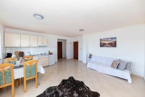 a kitchen and a living room with a bed and a table at Apartments Seaside in Bibinje