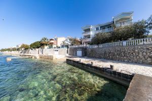 a view of the water with buildings and condos at Apartments Seaside in Bibinje