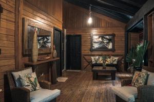 a living room with wooden walls and wooden floors at Platon Ecolodge in Santa Cruz de Barahona