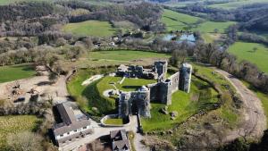 an aerial view of an old castle in a field at Bandar Cottage, farm cottage, close to Narberth, Pembrokeshire in Narberth