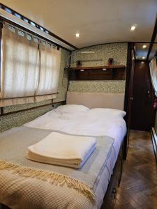 Una cama o camas en una habitación de Cosy Narrowboat Benedict, Clarence Dock Leeds