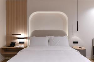 A bed or beds in a room at Zalo Urban Living Spaces