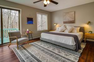 Un dormitorio con una cama y una silla y una ventana. en Lovely Poconos Cabin with Resort Amenities!, en Gouldsboro 29 fotos más