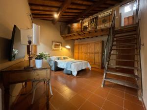 a bedroom with a bed and a spiral staircase at Da Giulia in Florence