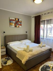 a bedroom with two beds and a window at Hotel Millenium Tirana in Tirana