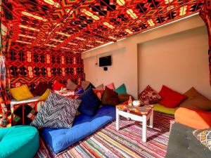 a living room with a couch with colorful pillows at La Perla Dahab in Dahab