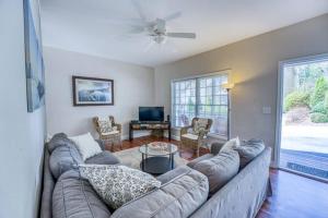 a living room with a large couch and a tv at Spacious Mountain House - 10 minutes from Asheville & Biltmore! in Asheville